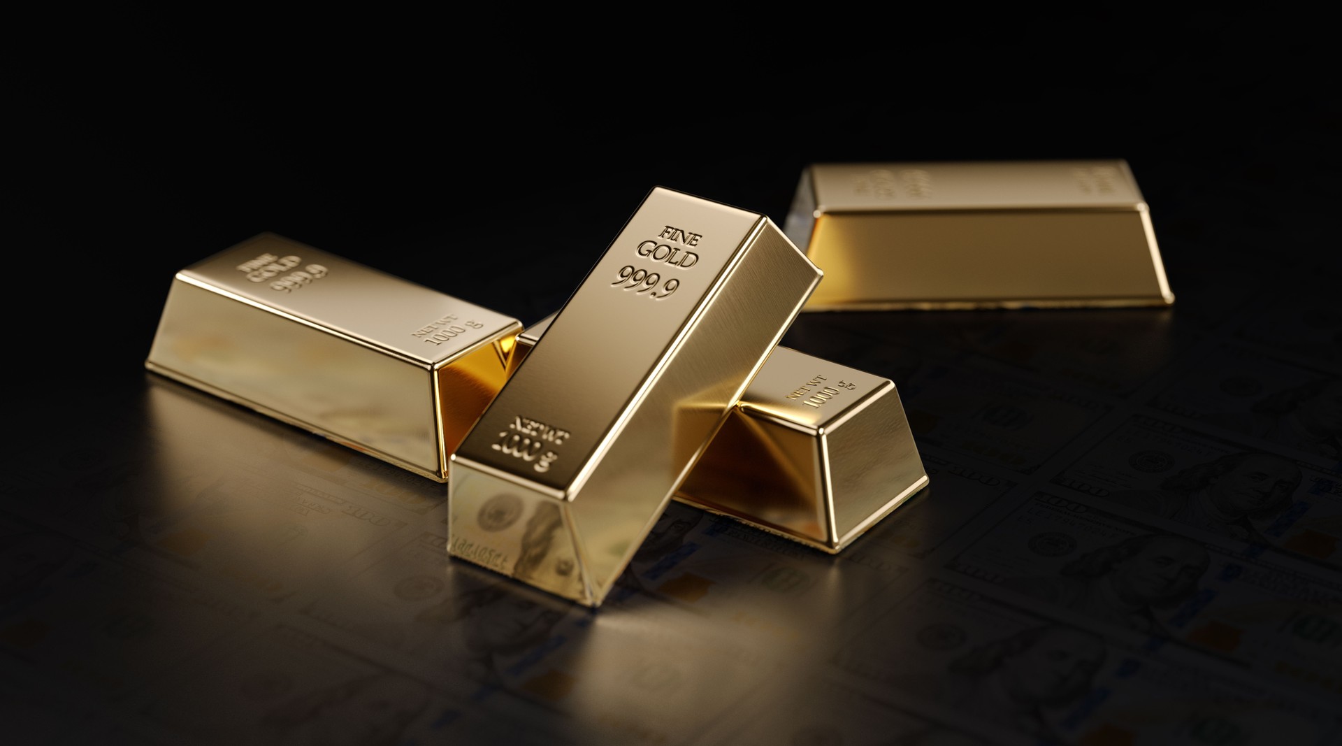 Gold Bars Sitting on One Hundred American Dollar Banknotes